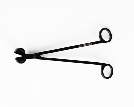 A black wick trimmer tool with metallic construction, designed for cutting candle wicks.